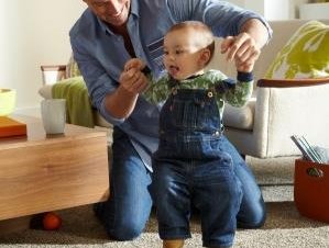 man playing with child on carpet