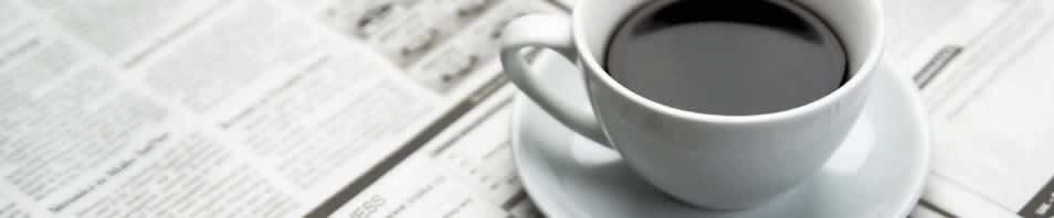 coffee mug on newspapers
